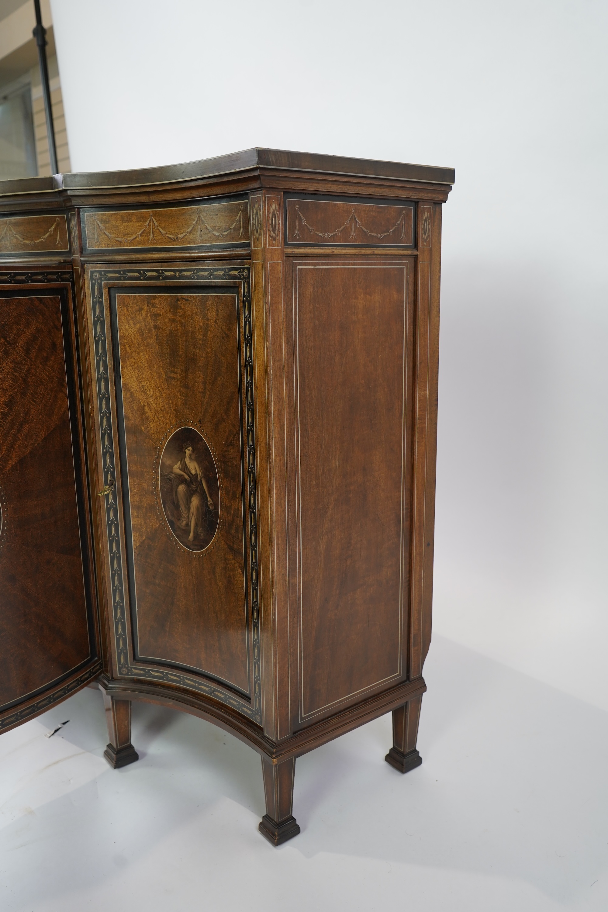 An Edwardian Sheraton Revival painted mahogany bowfront side cabinet
